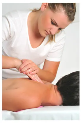 massage therapist working on client's upper back